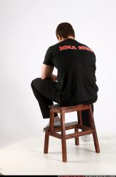 Alex Sitting With Pistol Pose